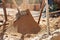 Sifting sand for mortar at the construction site. Purification of sand from impurities for the preparation of mortar for masonry