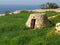 SIGGIEWI, MALTA - Mar 16, 2014: A Maltese girna. a traditional hut built from irregular stones in fields, by farmers for shelter