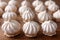 Sigh or homemade meringue is a sweet made from egg whites, sugar and lemon on the rustic kitchen wooden table