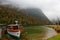 Sightseeing  Boat parking on Lake Konigssee with wooden pier and fallen leaves