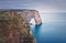 Sightseeing view to the Porte d\\\'Aval natural arch cliff washed by Atlantic ocean
