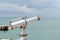 Sightseeing Vintage coin operated binocular overlooking for viewer ocean sea Beach