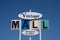 Sign for an abandoned antique mall called Vintage Mall. Retro sign against blue sky in mid