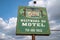 Sign for the abandoned Westward Ho Motel against a cloudy sky