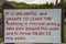 Sign along the geyser hot springs boardwalks in Yellowstone National Park reminding hikers to stay on the trail and not throw