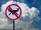 Sign banning drones on sky and clouds background.