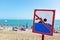 A sign on the beach is not allowed to swim! People bathe and rest on the sea in spite of the sign and ban