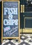 Sign on blackboard outside a pub in London promoting their Ultimate Fish and Chips, a great British favourite.