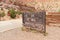 The sign for the Capitol Gorge area of Capitol Reef National Park. Sign missing most letters and is damaged