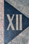 Sign on the cobblestones in the form of a Roman numeral twelve. Street paving. Cobblestone pavement