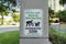 Sign on a concrete post outside with Clean Up After Your Dog Maximum Fine 250 at Miami, Florida