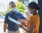 Sign, covid and black woman with a delivery at the door with a happy delivery man in a face mask for safety compliance