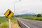 Sign curved road on the way at the natural  Field Or Meadow. Warning attention Right curve sign at Rural highway. Road sign showin