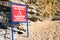 Sign Danger beware faling rocks on beach, Montenegro