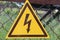 A sign of danger. Dark brown lightning against the yellow triangle