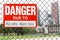 Sign danger due to alcohol addiction hanging on the fence