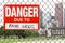 Sign danger due to fake news hanging on the fence