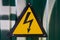 Sign of danger-lightning, on a green metallic background