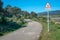 A sign of danger for loose animals on a country road dedicated to the activity of walking