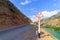Sign a dangerous curve on a mountain road, near the cliff. Uzbekistan, western Tien-Shan