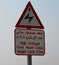 Sign in the desert in the Dubai warning of overhead electricity working