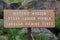 Sign at Devlis Tower National Monument reading Historic Wooden Stake Ladder Visible through viewing tubes