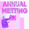 Sign displaying Annual Meeting. Business concept scheduled annually for the discussion of the business future Man