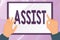 Sign displaying Assist. Concept meaning help them to do a job or task by doing part of the work for them Hands