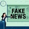 Sign displaying Fake News. Concept meaning false information publish under the guise of being authentic news Lady
