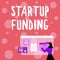 Sign displaying Start Up Funding. Concept meaning begin to invest money in newly created company or campaign Woman
