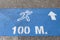 Sign with distance markings on a blue background at a park runway
