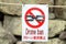 The sign with drone ban hangs on the rope.