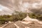 A sign of faith, a cross, beautiful clouds in a dry land at Cariri Paraiba Brazil Countryside