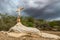 A sign of faith, a cross, beautiful clouds in a dry land at Cariri Paraiba Brazil Countryside