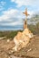 A sign of faith, a cross, beautiful clouds in a dry lroad at Cariri Paraiba Brazil Countryside