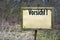 Sign on a forest path with the inscription Caution Vorsicht