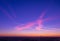 The sign or glyph painted on the sky by the clouds and contrails at sunset