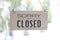 A sign hanging off Coffee shop door,Close sign blur background,Label word close