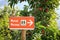 Sign with hiking symbol and apple trees in Merano, South Tyrol