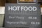 Sign - Hot Food Available here - Beef Pasty or vegetarian Pasty - England in window with food in background - selective focus