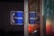 Sign indicating the presence of a public phone booth in Chinatown Toronto, Ontario, at night.