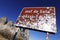 Sign indicating the Sella Pass covered with stickers pasted by tourists.