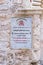 A sign with the inscription - The Syrian orthodox church - in two languages - Arabic and English near the entrance to the church i