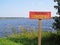 Sign in Lake Shore Water Saying in Russian Swimming Forbidden