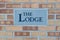 Sign \'The Lodge\' on a brick wall