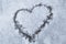 Sign of love-heart painted on snow, pastel blue background, Valentine's day