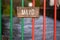 Sign Mayo on a wooden board and on metal fence in county color. Selective focus. Small river in the background