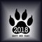Sign of the new year in the form of a trace of a dog`s paw. Vector.