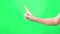 Sign NO on green screen background. Closeup view of one single male hand making no gesture isolated on greenscreen