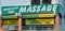 A sign offering Brazilian and and Thai massage. Algarve is a popular destination for Brits